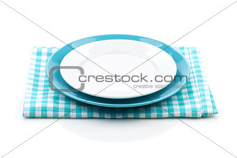 Empty plates over kitchen towel