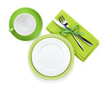 Empty green plates, coffee cup and silverware