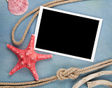 Blank photo frame with seashells, ship rope, sea stones