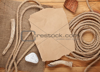 Old paper and rope on wooden textured background
