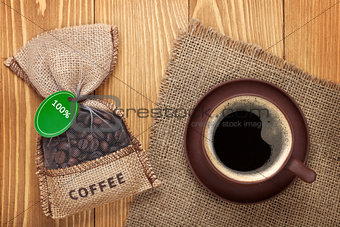 Coffee cup and small bag with beans