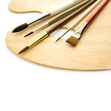 Art brushes with wooden palette isolated