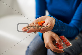 asian woman holding pills and medicine in hand