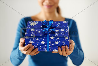asian girl holding gift box to the camera
