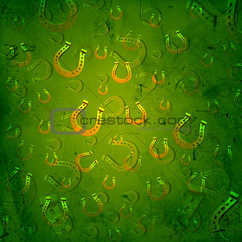 golden horseshoes in green old paper background