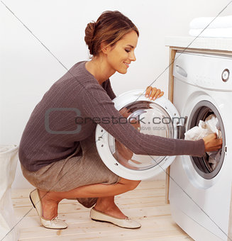 young housewife doing laundry