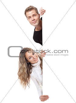 Young couple holding an empty board