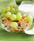 healthy breakfast of muesli with milk and green grapes