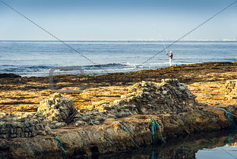Rocky Coast and See with Fisherman