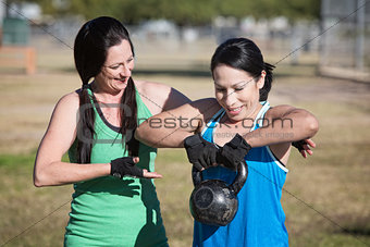 Woman Assisting Student with Weights