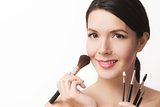 Beautiful woman with cosmetic brushes