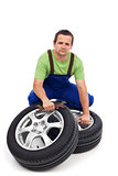 Car mechanic with new tires