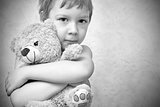 Young boy hugging teddy bear, portrait