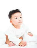 cute newborn infant baby sitting and looking