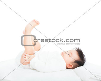 happy baby playing and raise his feet