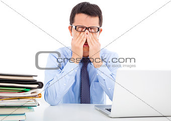 businessman is too fatigued to rubbing his eyes