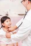 male pediatrician examining little girl