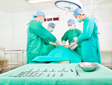 Team surgeon at work in operating room. a table with tools