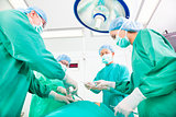 Team surgeon  working in operating room.