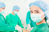 Woman surgeon working with team in a surgical room