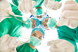 Surgeons and assistant operating with surgical instruments