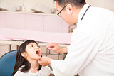 pediatrician examining  kid throat with  tongue depressor 