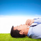 young businessman thinking   and contemplating on a meadow