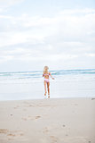 Young girl running at beach