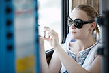 Woman taking pictures at her mobile on a bus