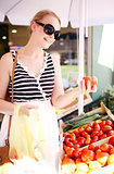 Young woman shopping for fresh tomatoes