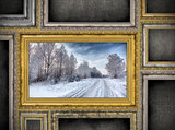 golden wooden frame with beautiful landscape among other empty f