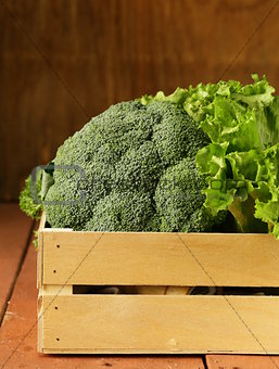 broccoli cabbage and lettuce in a wooden box