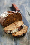 Rye bread with dried apricots and a knife.