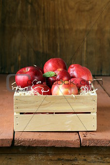 fresh ripe organic red apples in a wooden box