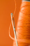 eye of a needle with a thread close up