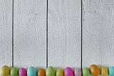 Easter or Spring Themed Background of Old Wood and Colored Eggs 