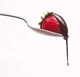 sweet fruit strawberry in chocolate syrup on silver spoon