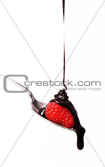 sweet fruit strawberry in chocolate syrup on silver spoon