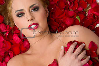 Almost Nude Woman in Red Rose Flower Petals