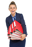 Smiling business woman with stack of folders