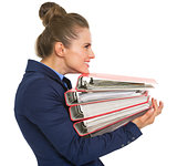 Profile portrait of happy business woman with stack of folders