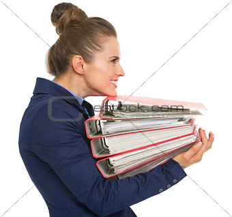Profile portrait of happy business woman with stack of folders