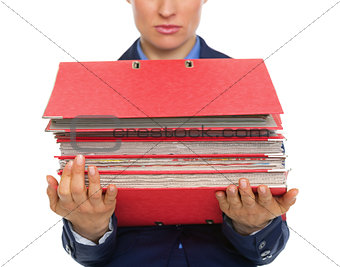 Closeup on business woman with stack of folders