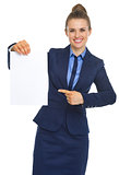 Happy business woman pointing on document