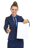 Smiling business woman giving document and pen