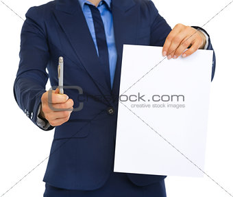 Closeup on business woman giving document and pen