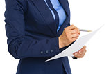Closeup on business woman examining document