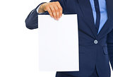 Closeup on business woman showing blank paper sheet