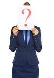 Business woman hiding behind paper sheet with question mark