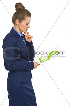 Thoughtful business woman looking on paper sheet with dollar sig